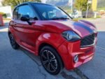 Vue latérale extérieure, microcar compacte garée en ville
